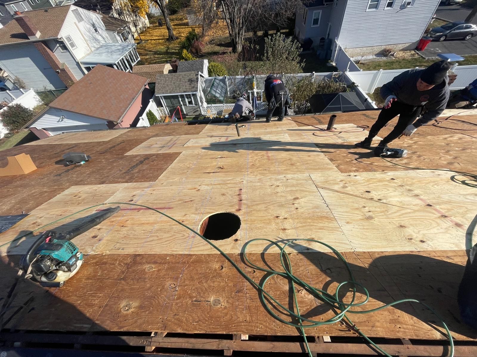 A group of people are working on a roof.