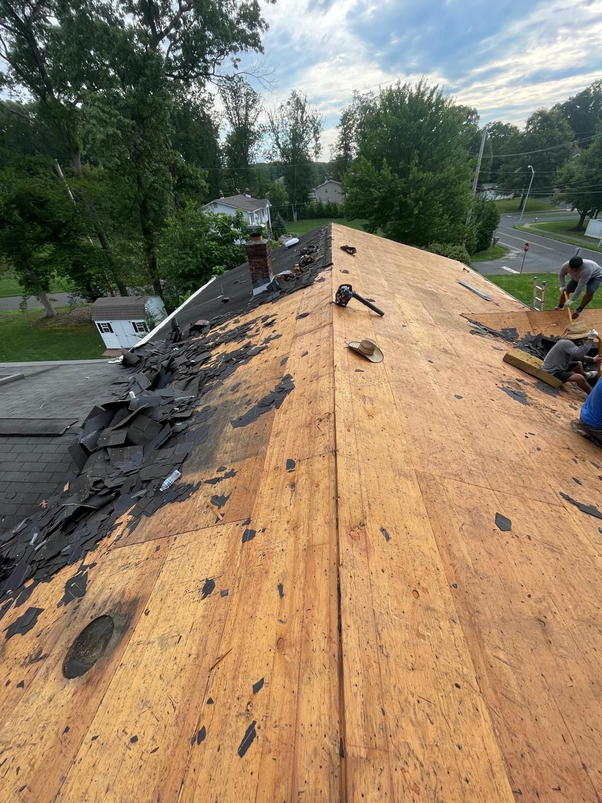 A man is working on the roof of a house.