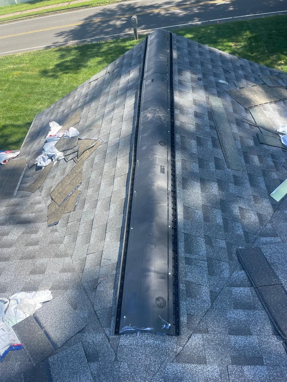 A close up of a roof with a drain on it.