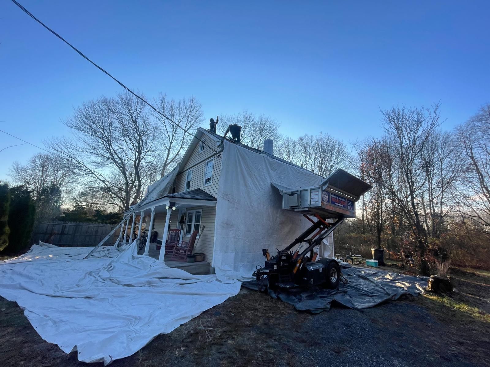 A house is covered in a white tarp.