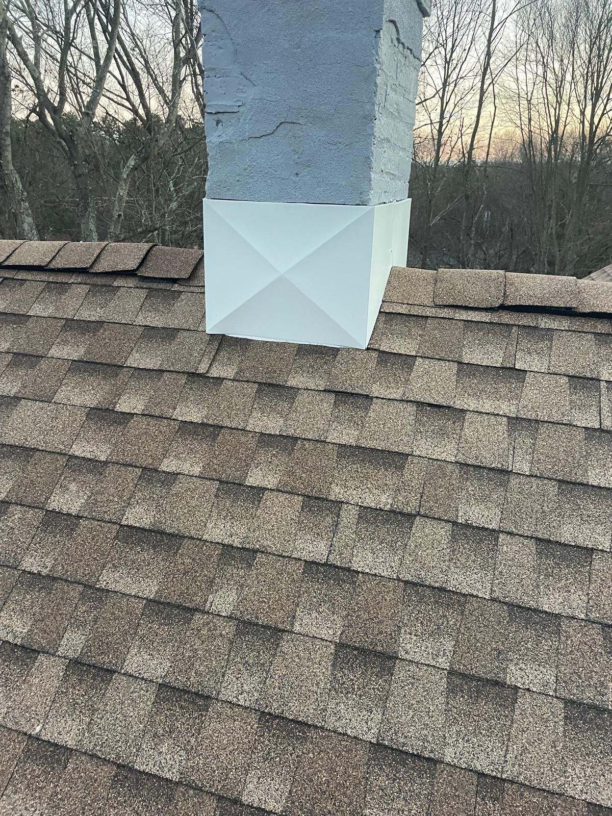 A chimney is sitting on top of a roof
