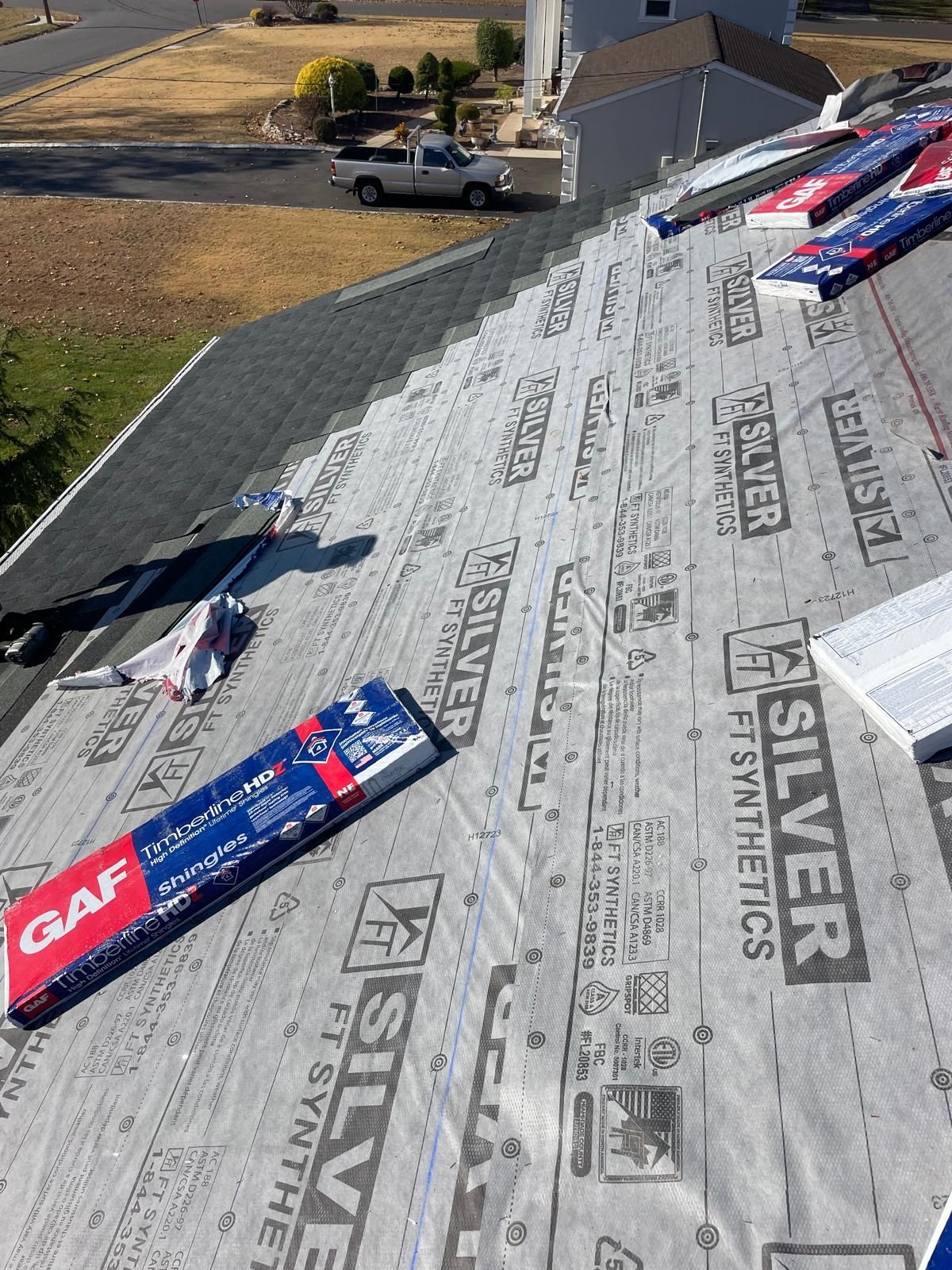 A roof with a lot of roofing material on it.