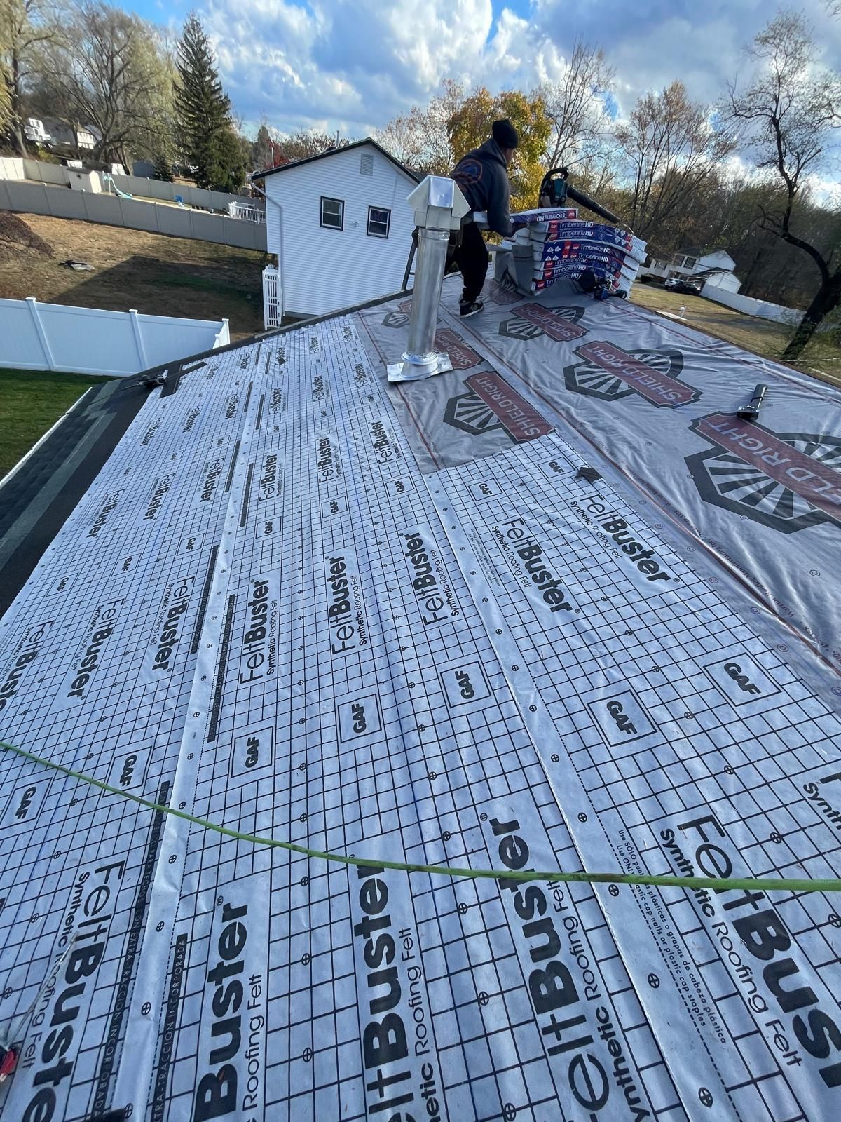 A man is working on the roof of a house.