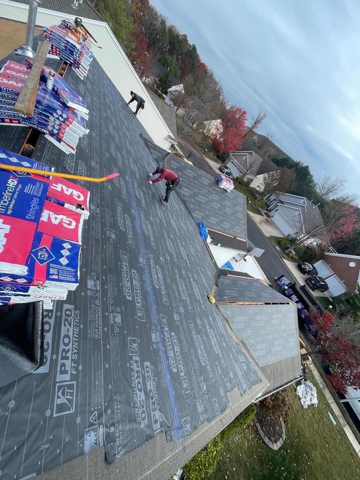 A man is working on the roof of a house.