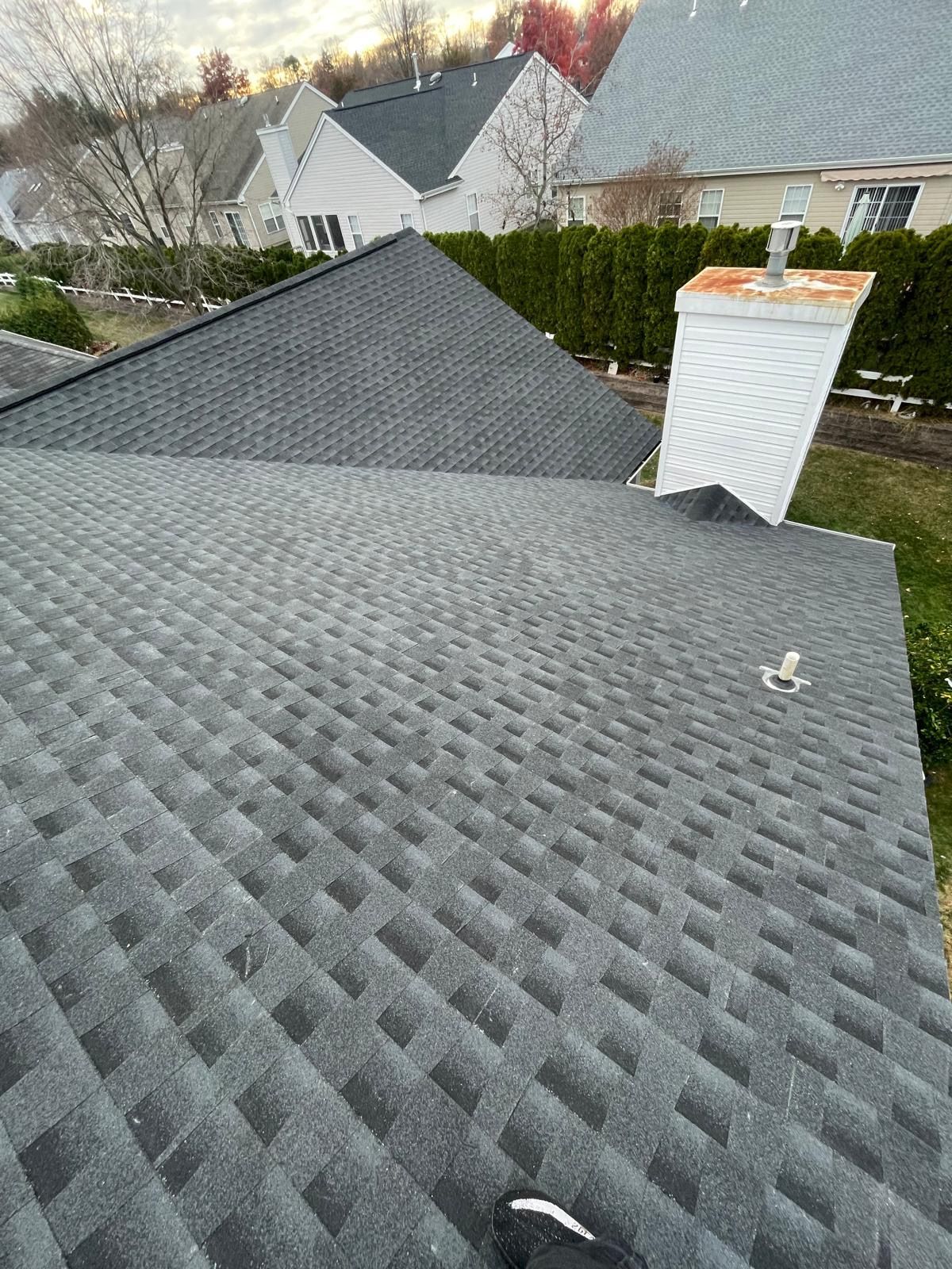 A close up of a roof with a chimney on top of it.
