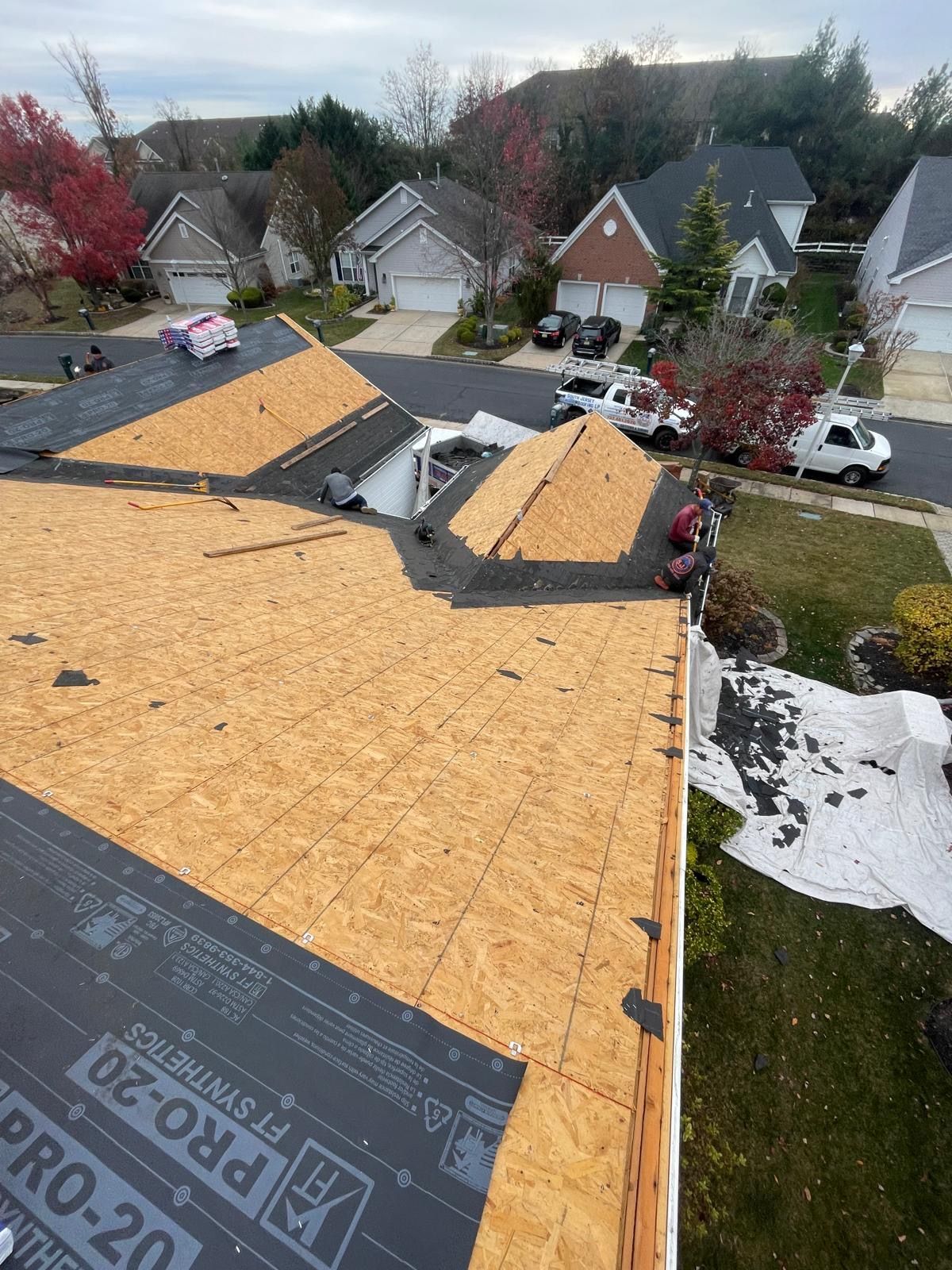 A roof is being installed on a house in a residential area.