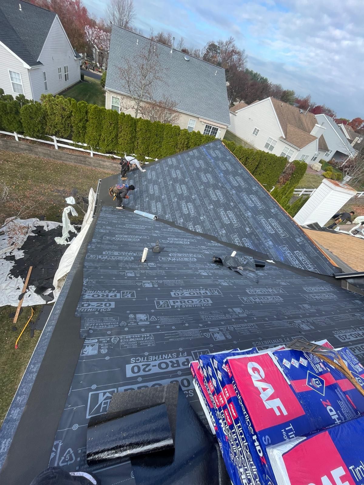 A roof is being installed on a house in a residential area.