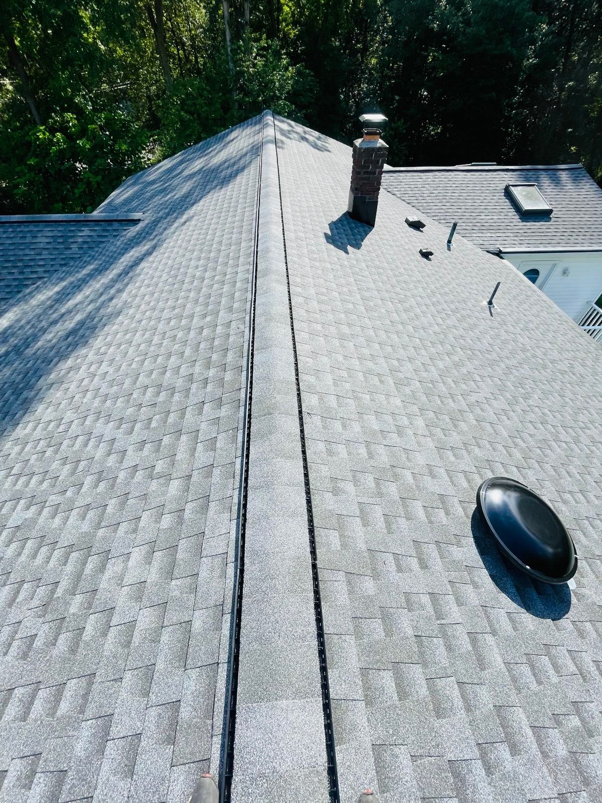 A close up of a roof with a chimney on it.