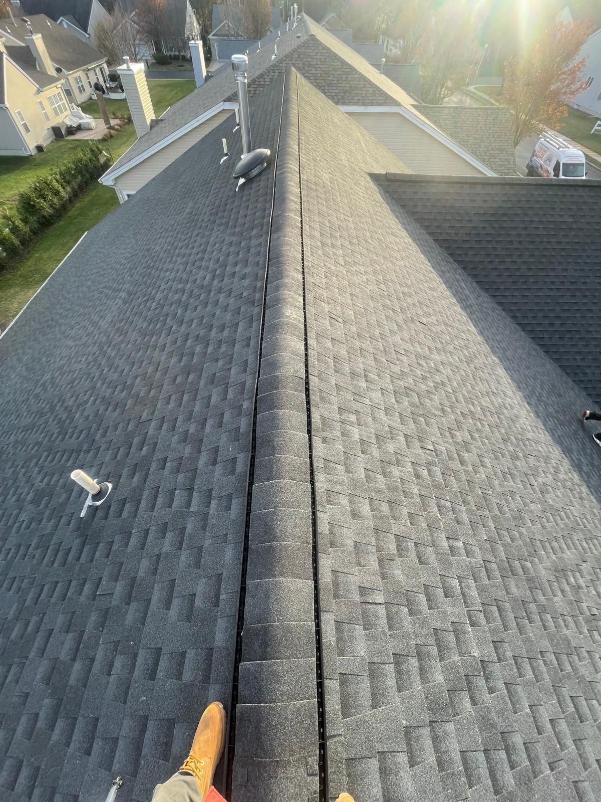 A person is standing on the roof of a house.