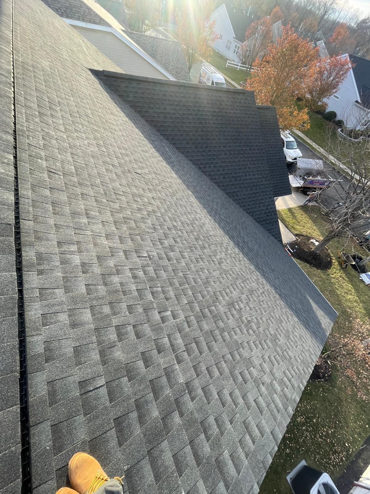 A person is standing on the roof of a house.