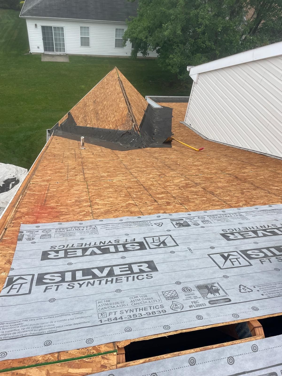A roof with a silver ft synthetic roofing material on it