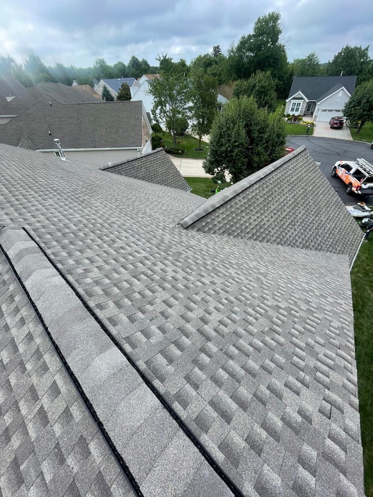 A roof with a lot of shingles on it in a residential area.