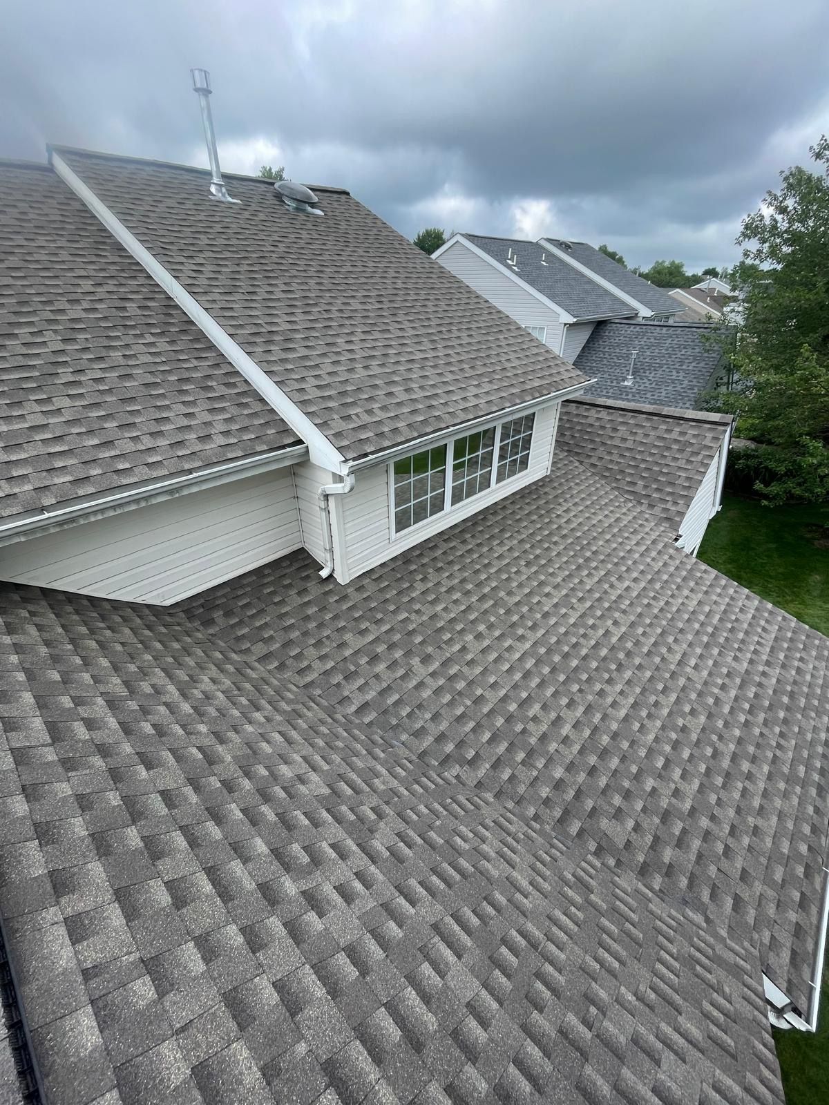 An aerial view of a roof of a house with a lot of windows.