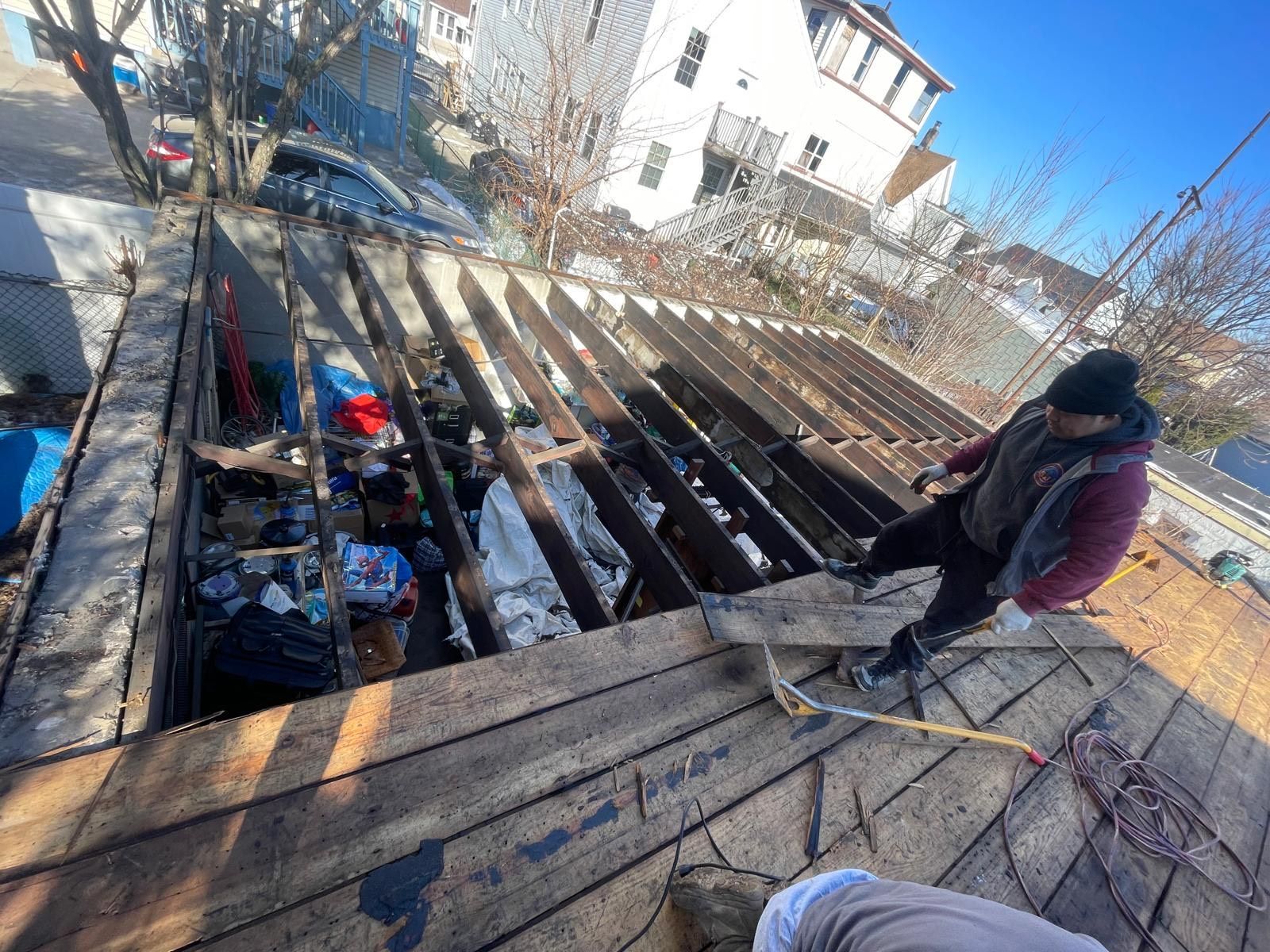 A group of people are working on a wooden deck.