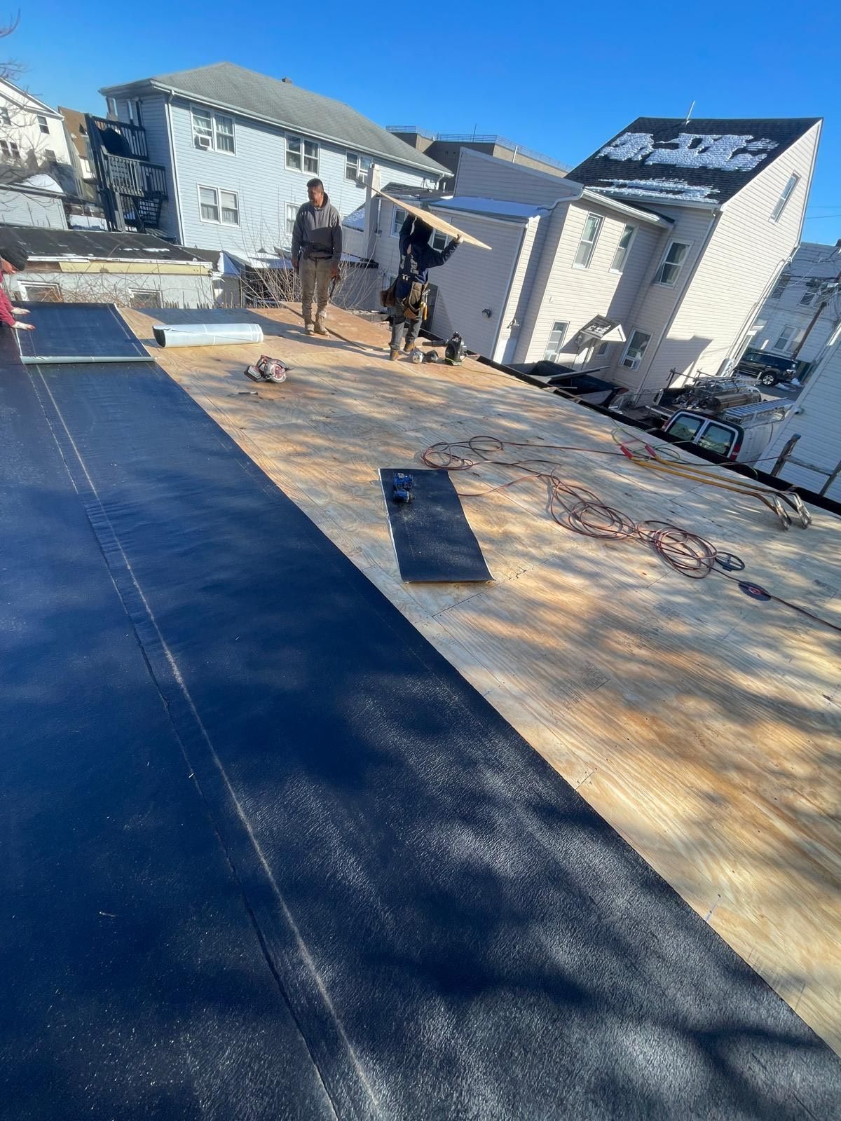 A couple of people standing on top of a roof.