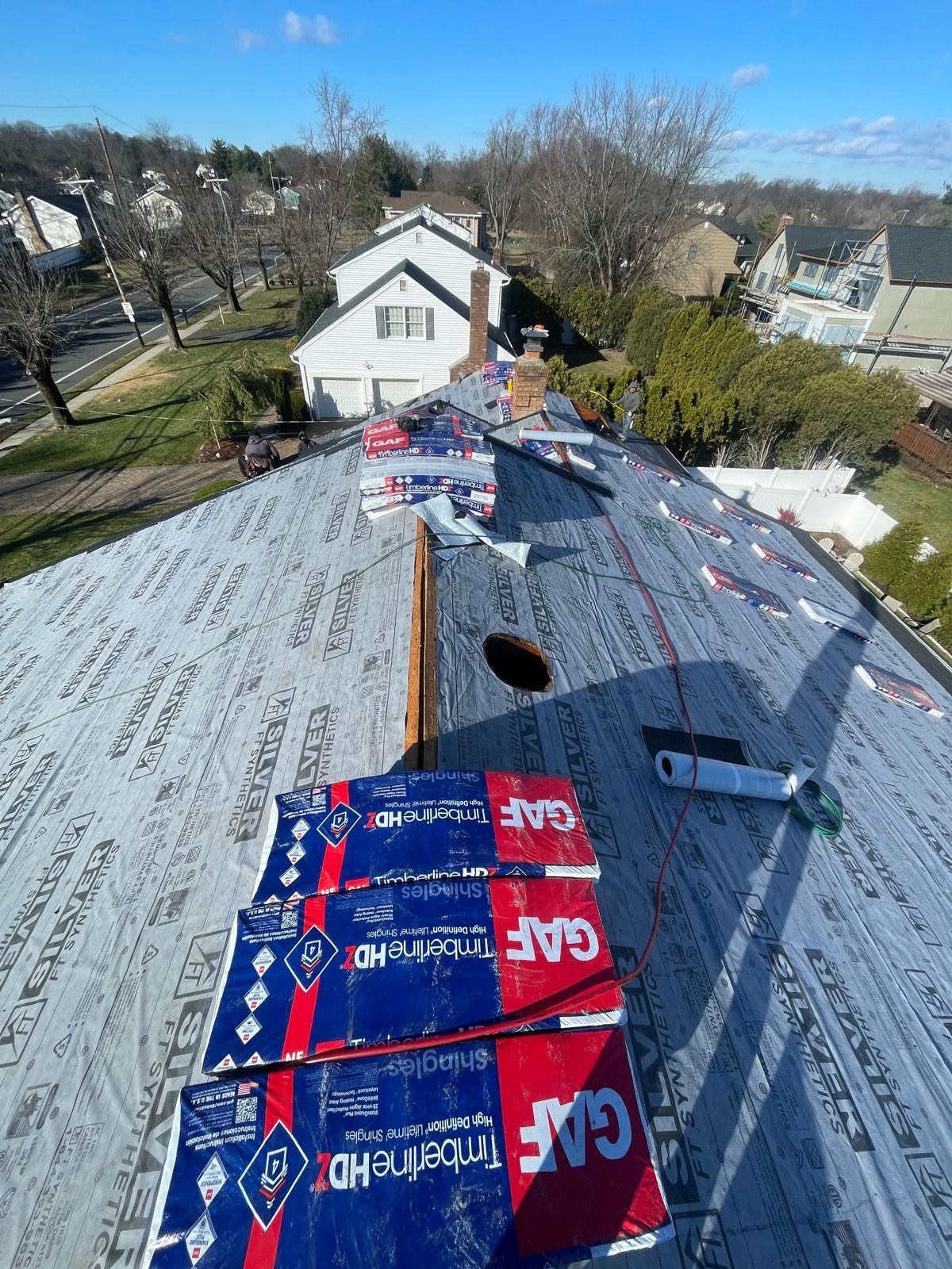a roof with a hole in it and a bunch of boxes on it