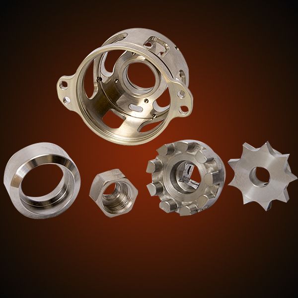 Close-up of several precision-machined metal parts: housing, nut, sprocket, and ring, arranged against a gradient background.