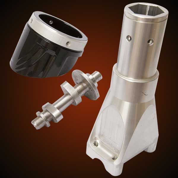 Metal machine parts on a gradient background, including a hexagonal tool head, a shaft, and a black/silver cylindrical component.