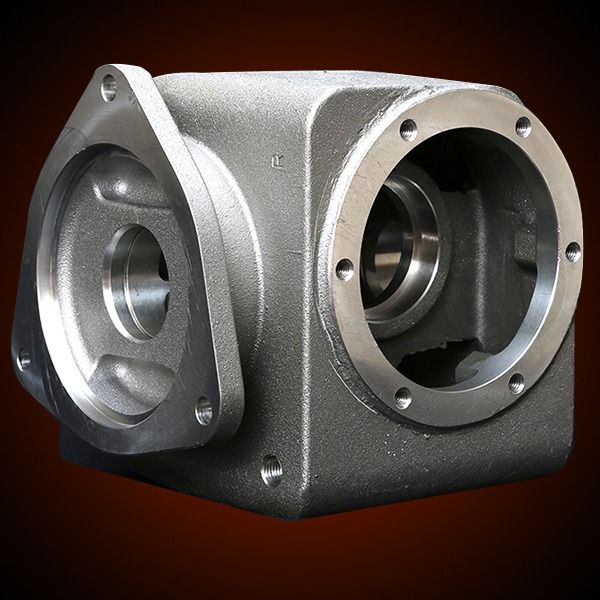Metal gearbox housing with three openings and flanges.