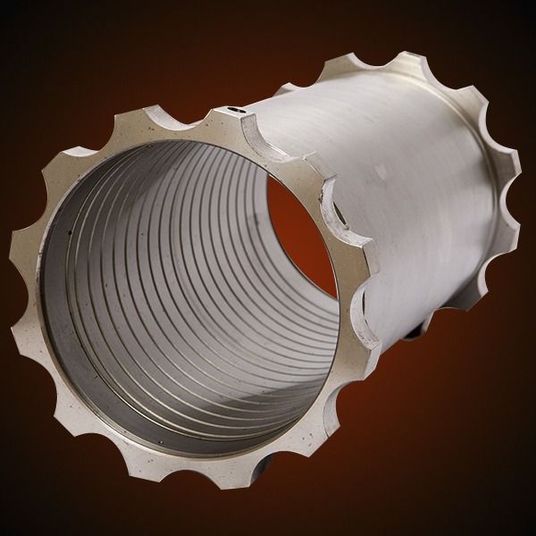 Metallic cylindrical device with ridged interior and scalloped edge.