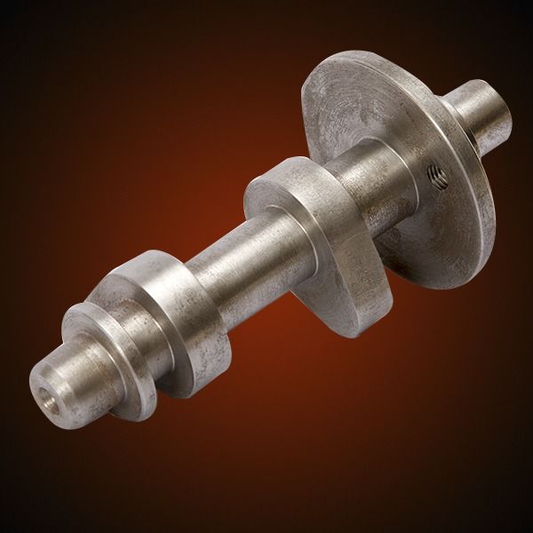 Metal camshaft with several lobes and flanges against a brown background.