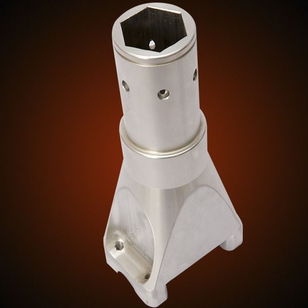 Silver metal part with a hexagonal socket and a triangular base.