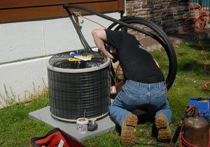 HVAC contractor fixing an air conditioning unit