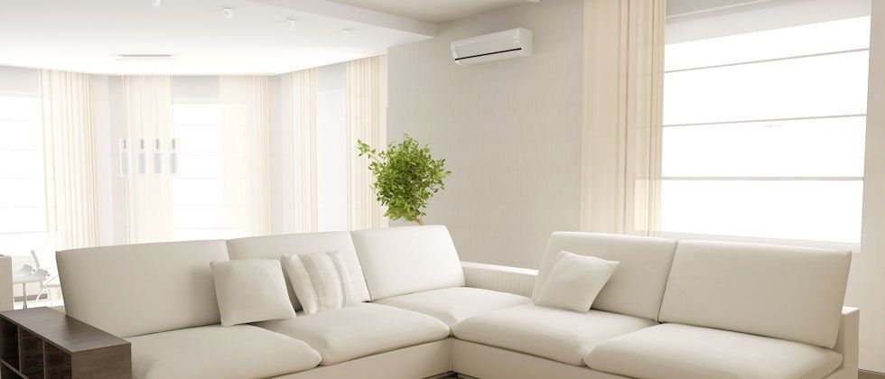 A nice, white living room with wall air conditioning unit