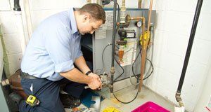 Technician making a heating system repair