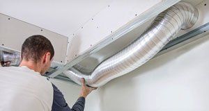 Technician installing air ducts
