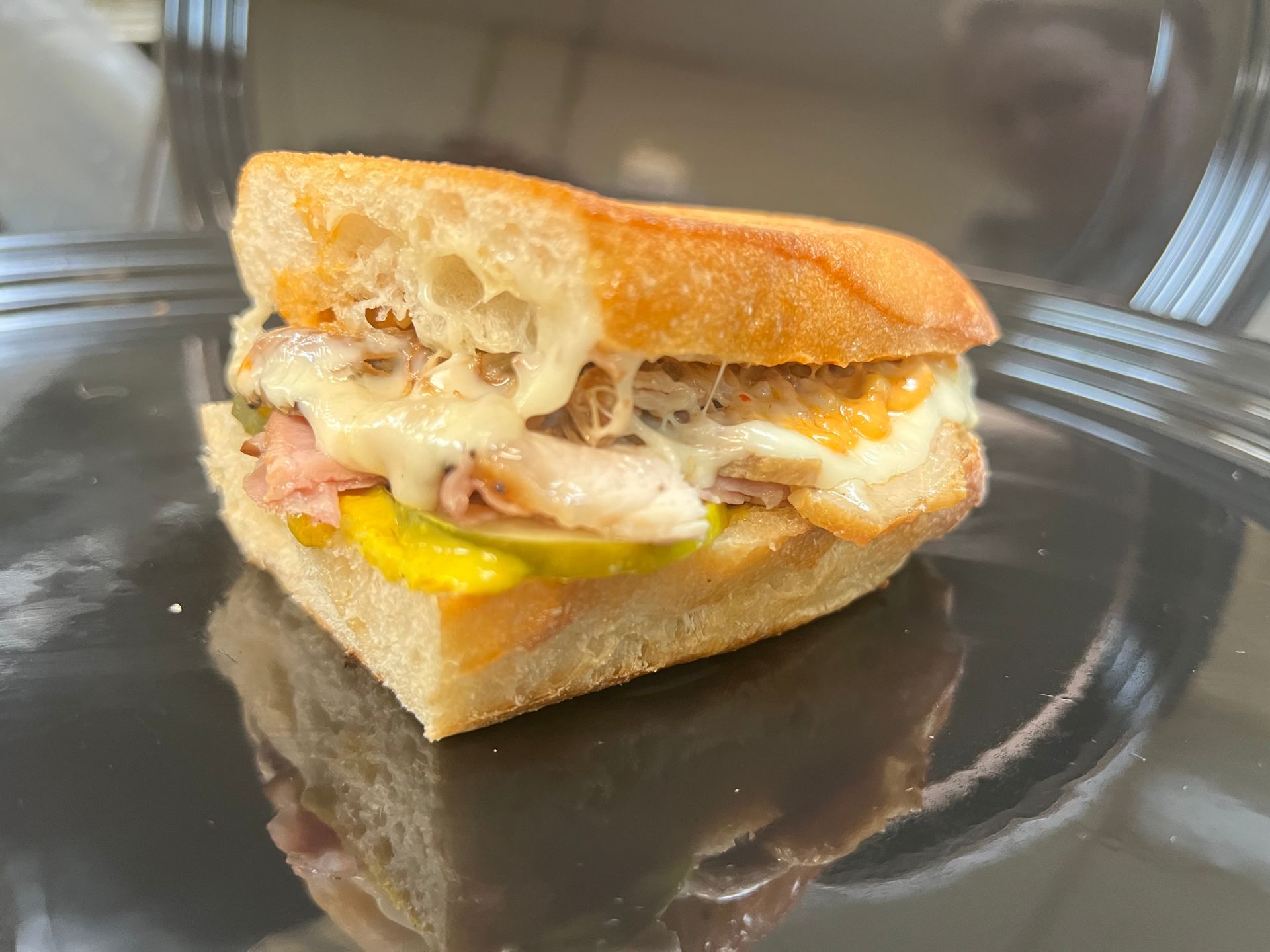 a sandwich and chips are on a piece of tin foil on a table