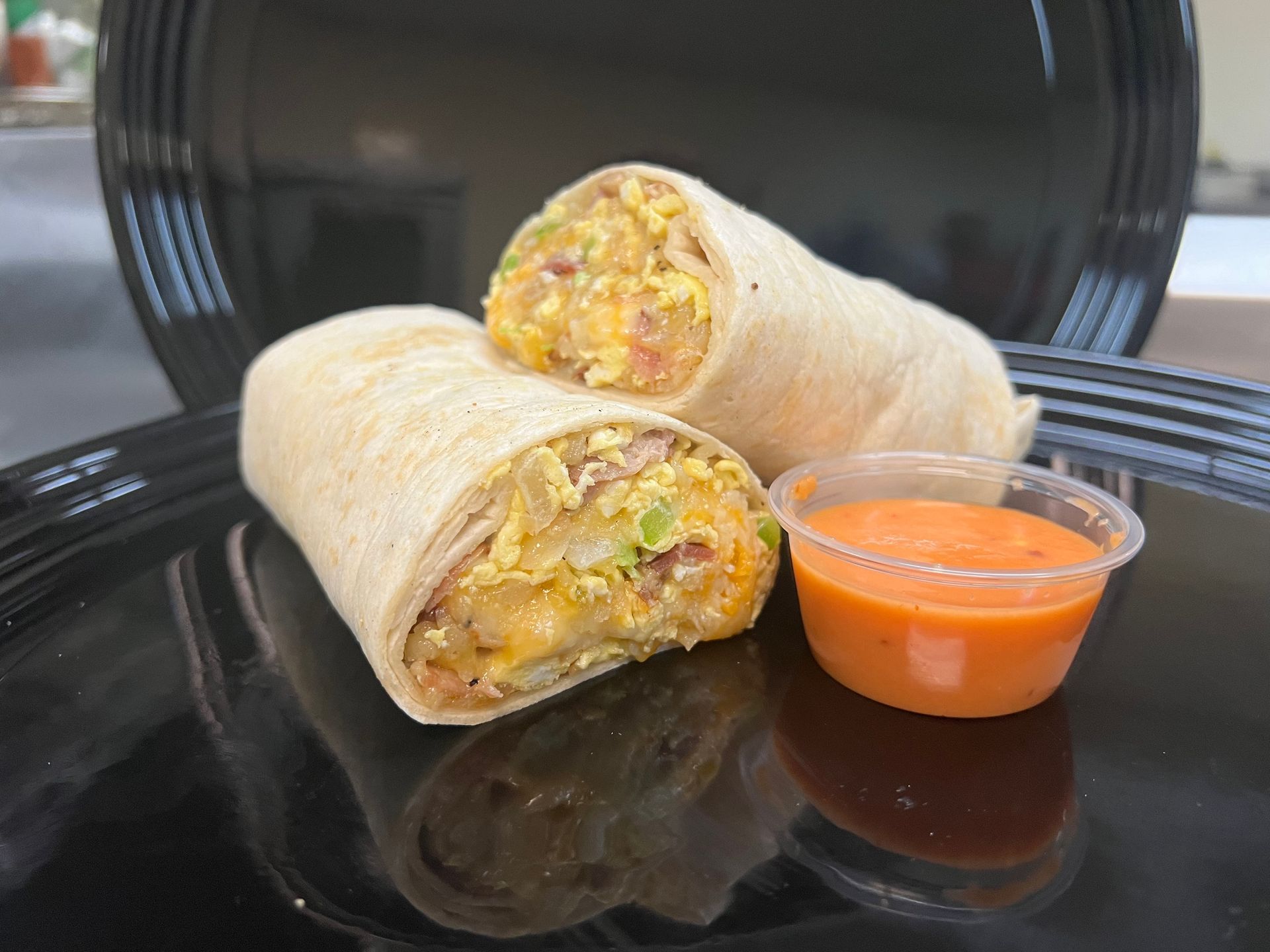 a sandwich on a white plate with a slice taken out of it