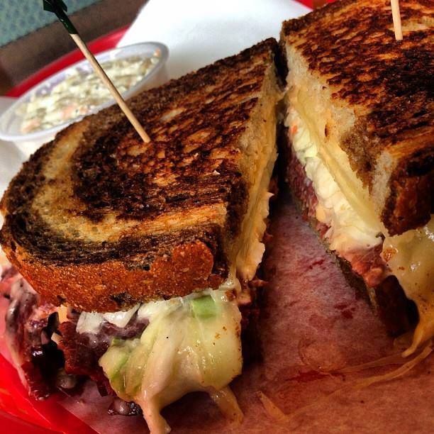 a grilled cheese sandwich is cut in half on a red plate