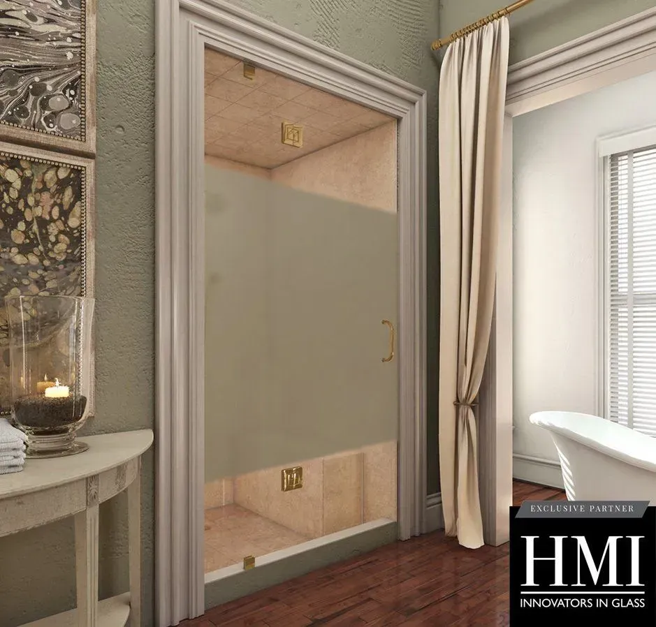 A glass shower door with a wide, frosted horizontal strip, installed in a tiled bathroom with gold-tone hardware.