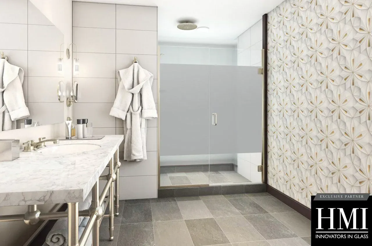A modern bathroom featuring a marble vanity with a vessel sink, a white robe hanging on the wall, and a glass shower.