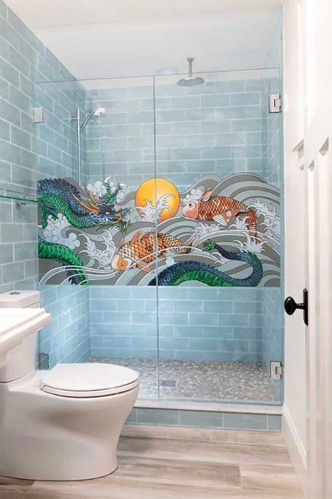 A bathroom with a walk-in shower featuring a vibrant mosaic of a green dragon and orange tiger against a blue tiled wall.