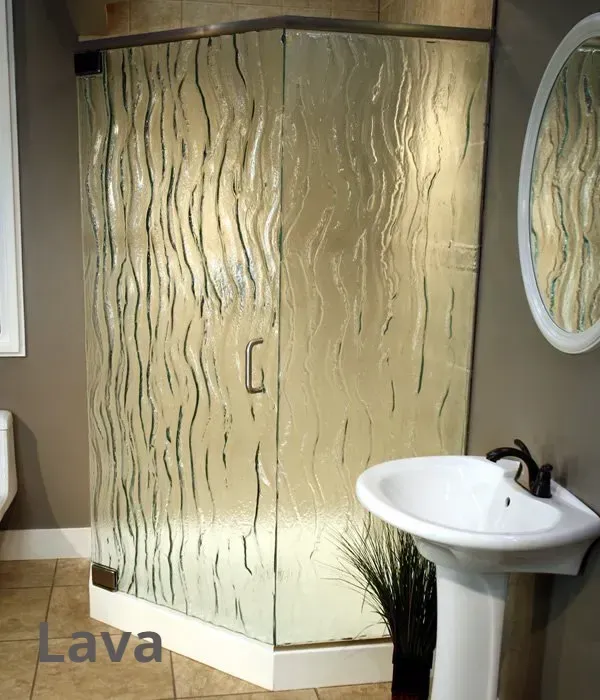 A neo-angle glass shower enclosure with a vertical wavy