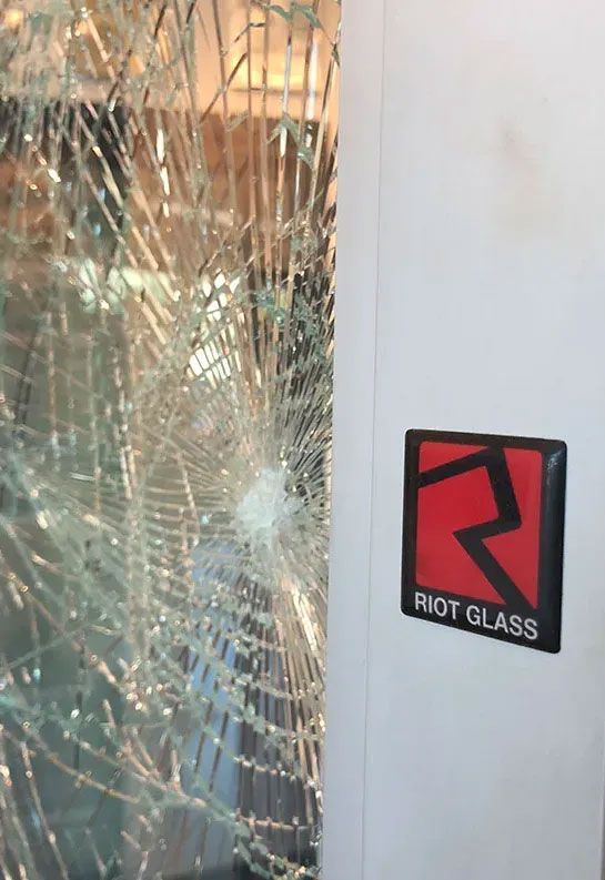 A shattered glass panel next to a black and red