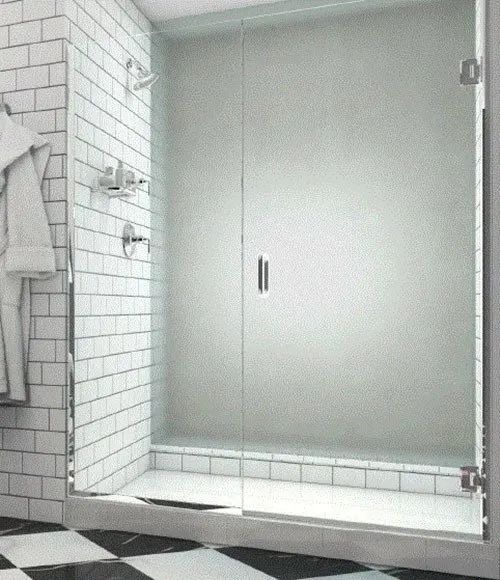 A glass-enclosed shower with white subway tile walls and a black and white checkerboard floor.