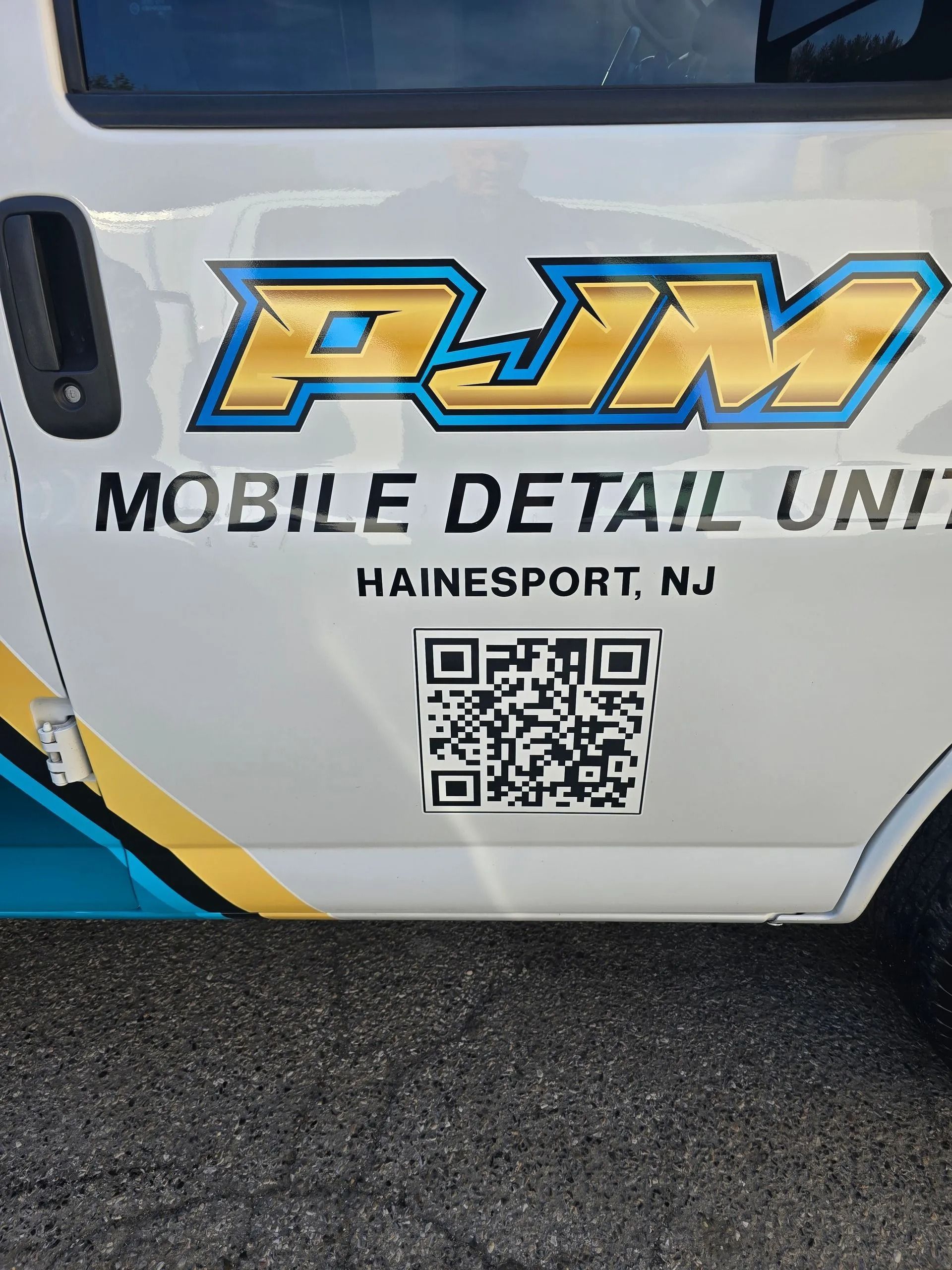 Side of a white van for PJM Mobile Detail Unit in Hainesport, NJ, featuring a large QR code.