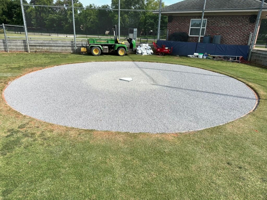 Circular gravel area for a sport, with green grass surround.