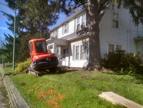 Mini excavator in lawn