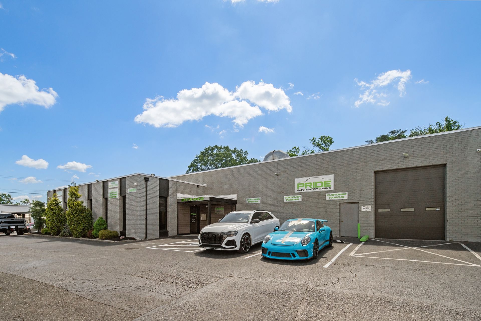Two cars are parked in front of a building