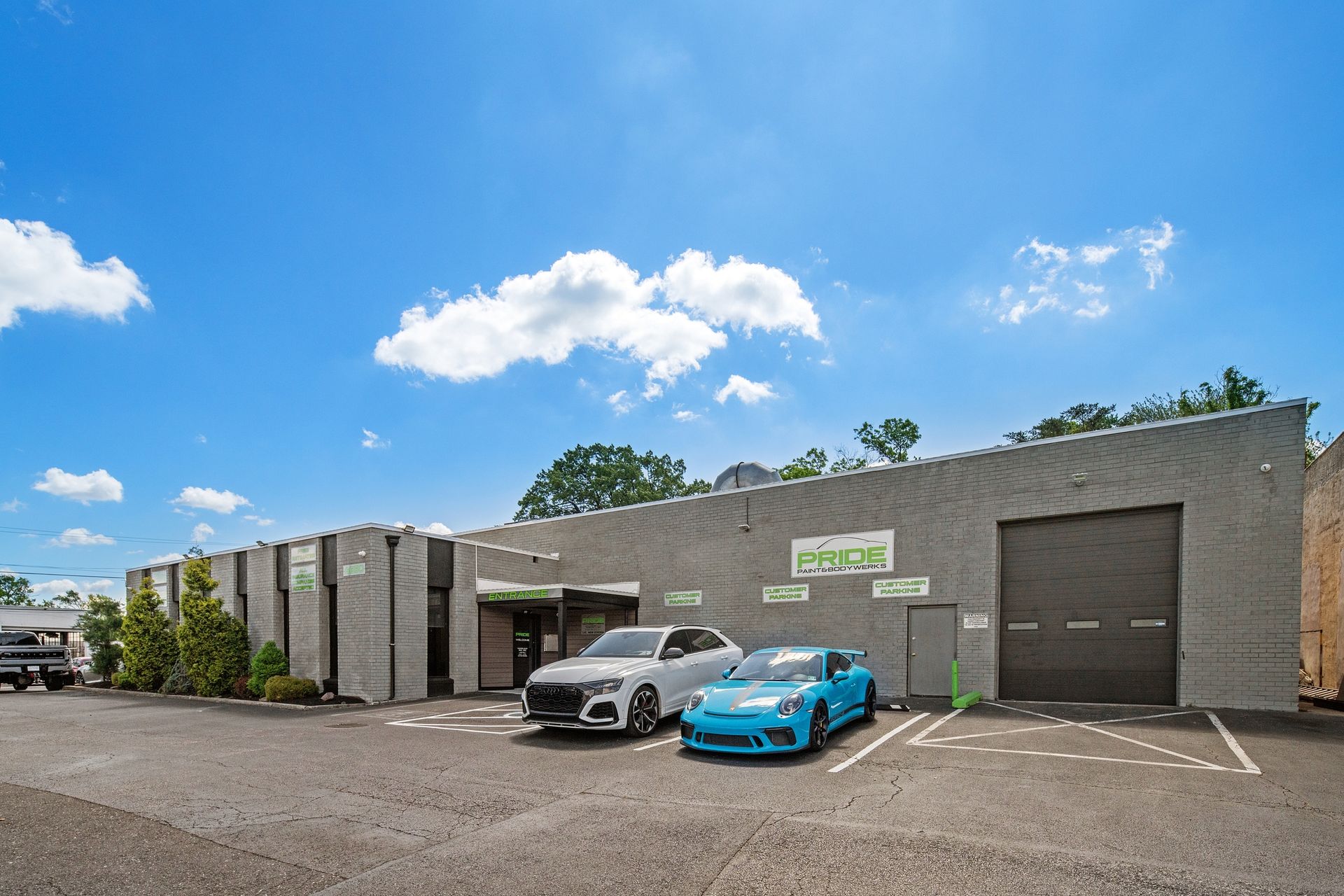 A couple of cars are parked in front of a building