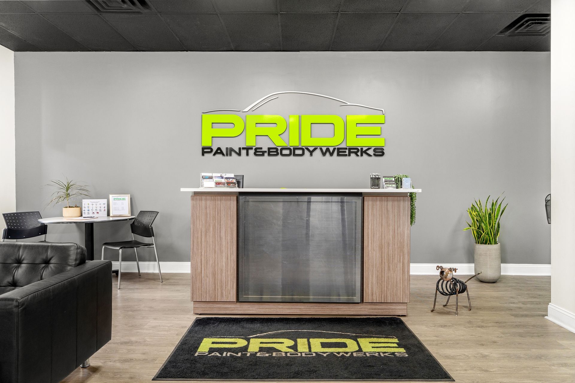 A reception area for pride pants and bodyworks with a dog on the floor