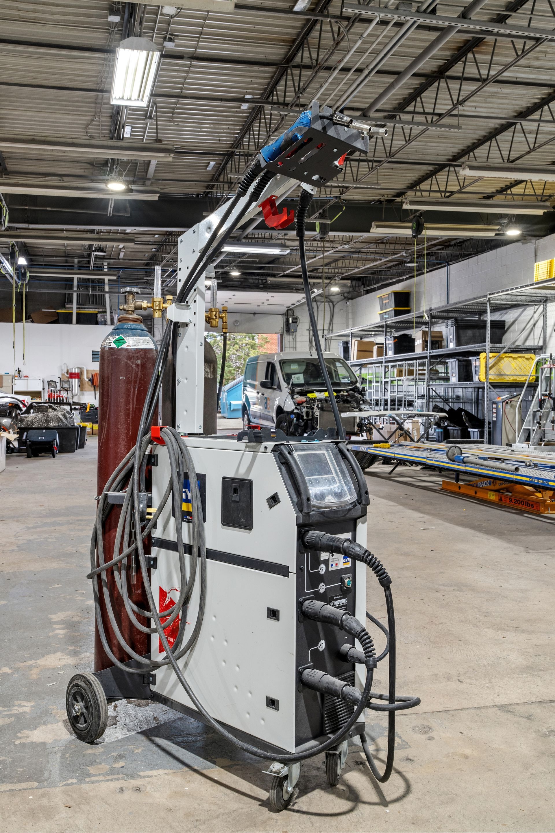 A welding machine is sitting in a warehouse