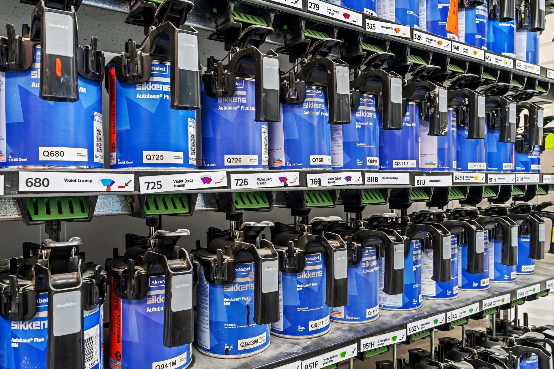 A shelf filled with lots of blue cans of paint