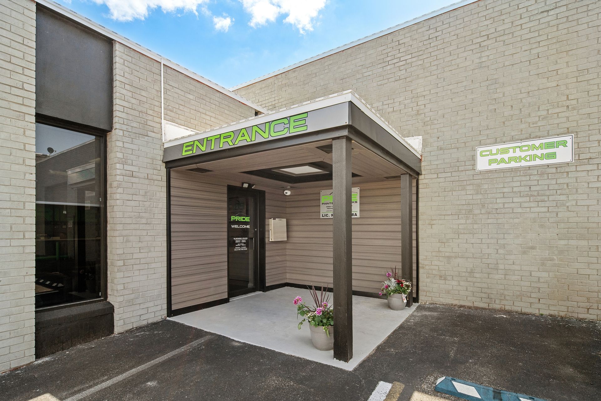 A brick building with a sign that says entrance on it