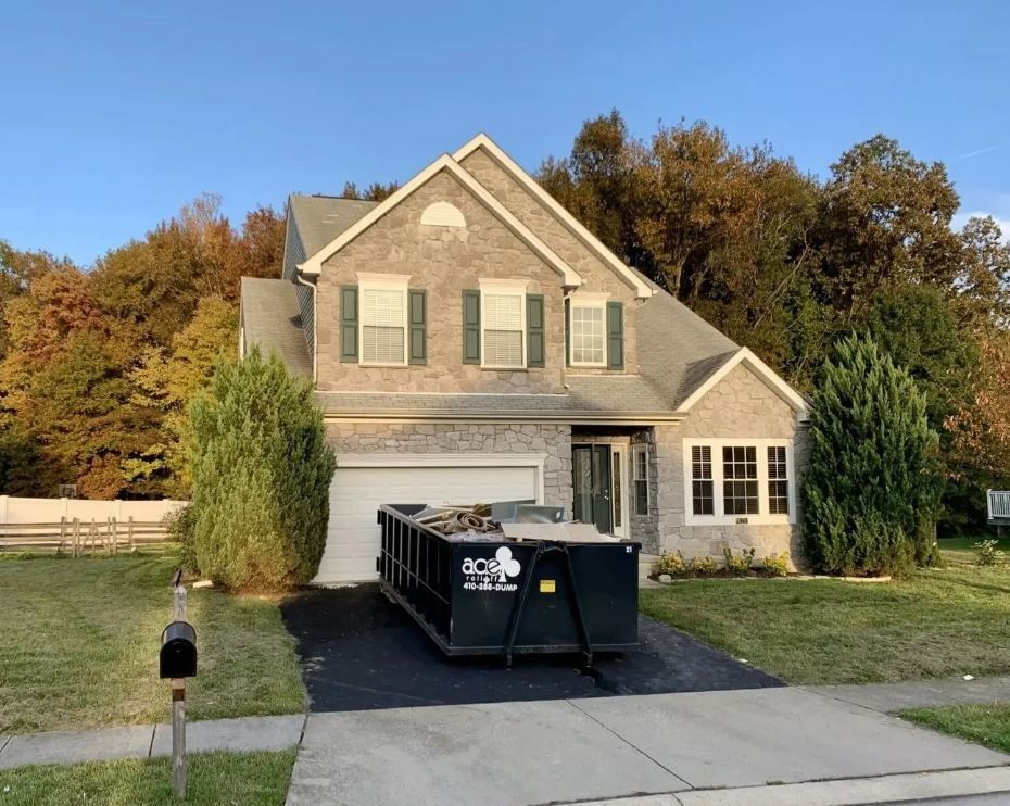 a dumpster is on the driveway in Perry Hall, MD