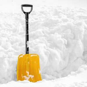 A yellow snow shovel stands upright in a large, deep pile of white snow.